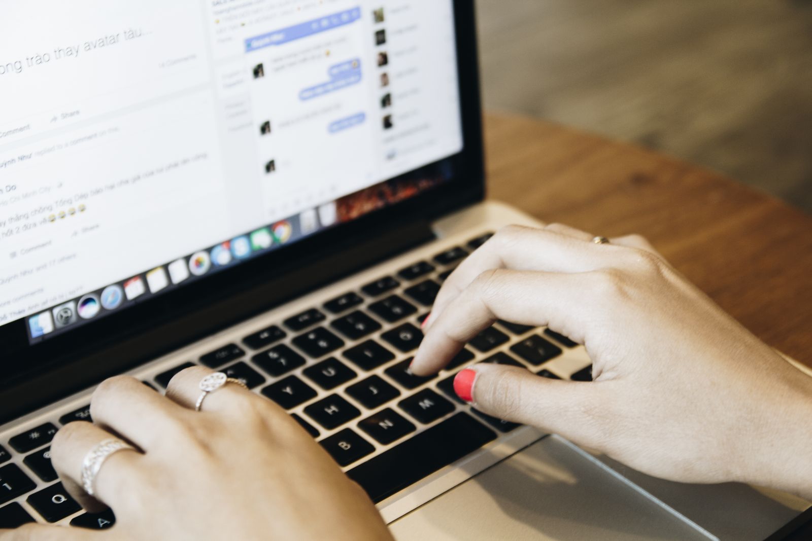Hands typing on a laptop with a messaging app open