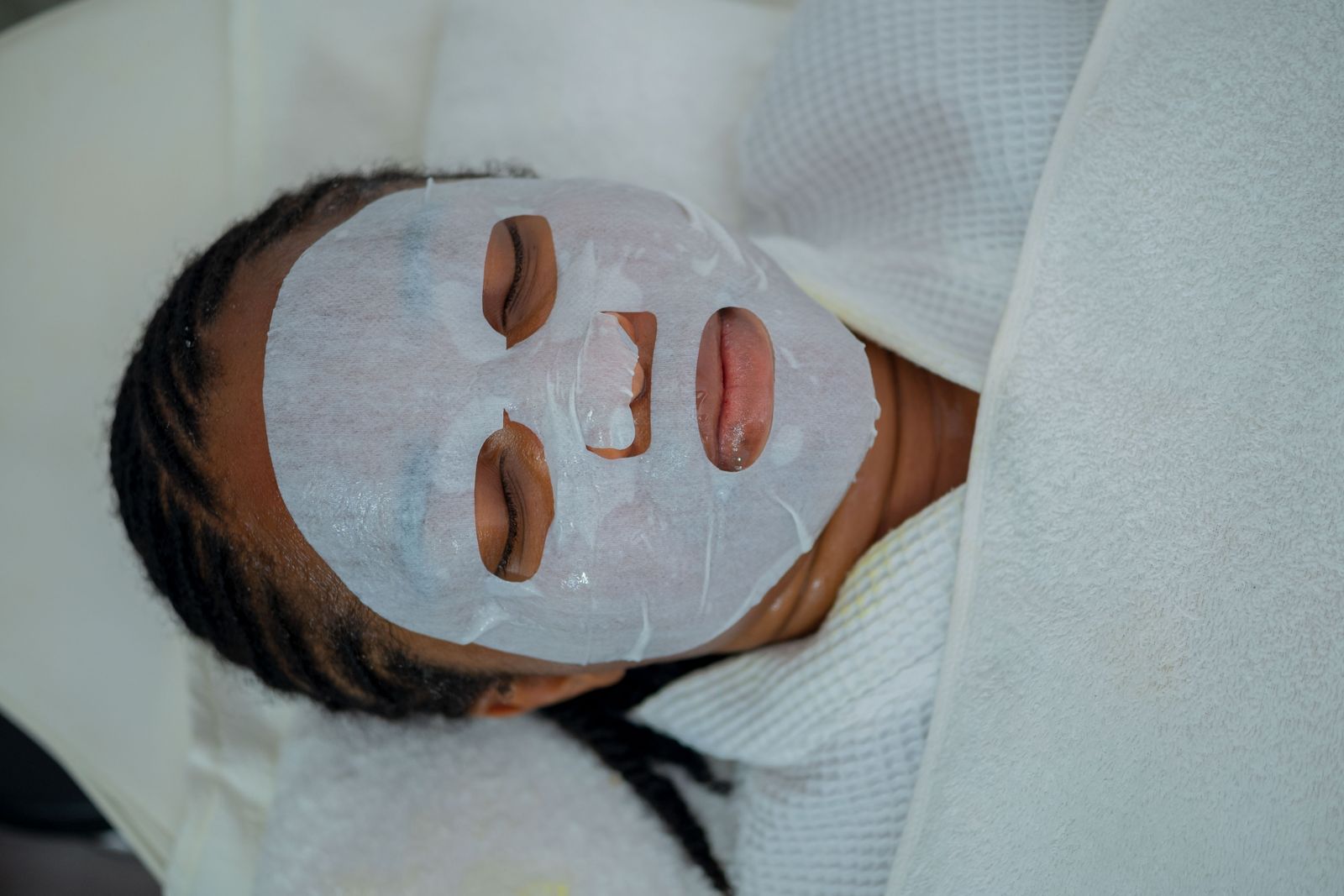 Woman receiving a facial mask treatment at a spa