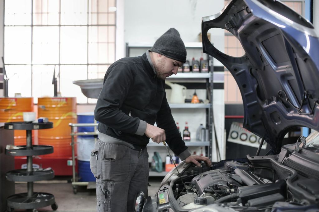 Mechanic working on a car engine in a garage