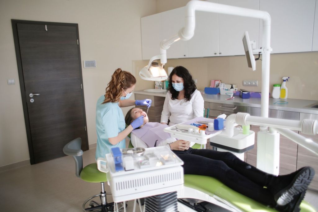 Dentist and assistant treating a patient in a dental clinic