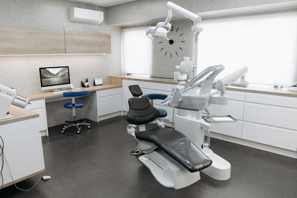 Modern dental treatment room with dental chair and equipment