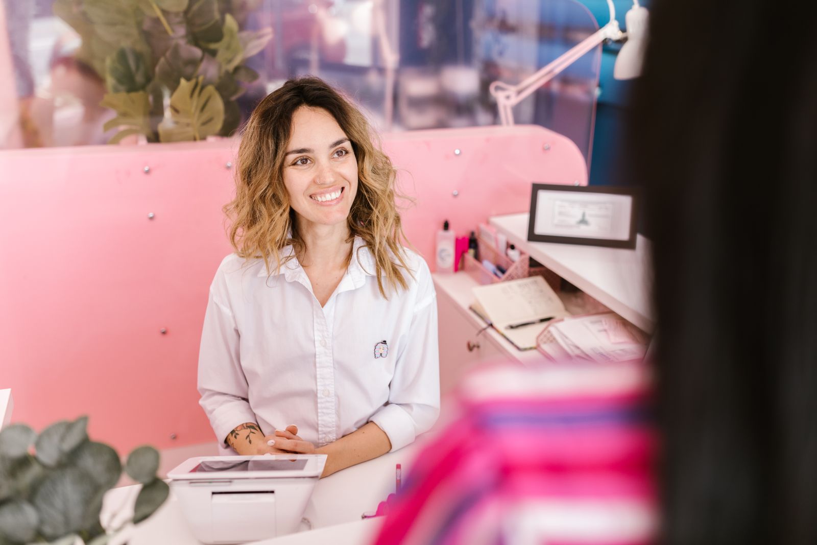 Smiling receptionist welcoming clients at a front desk