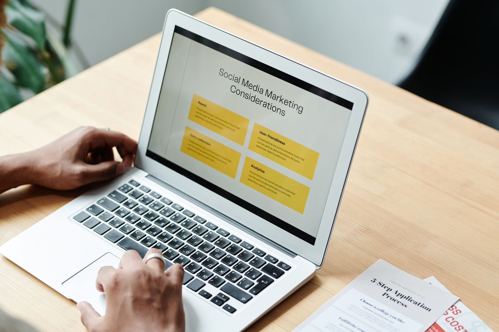 Person reviewing a social media marketing plan on a laptop