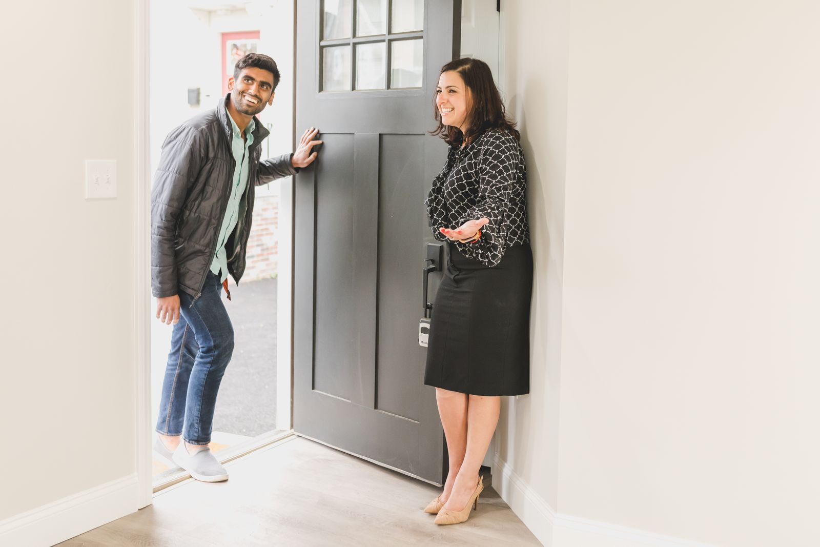 Sales representative greeting a homeowner at the front door